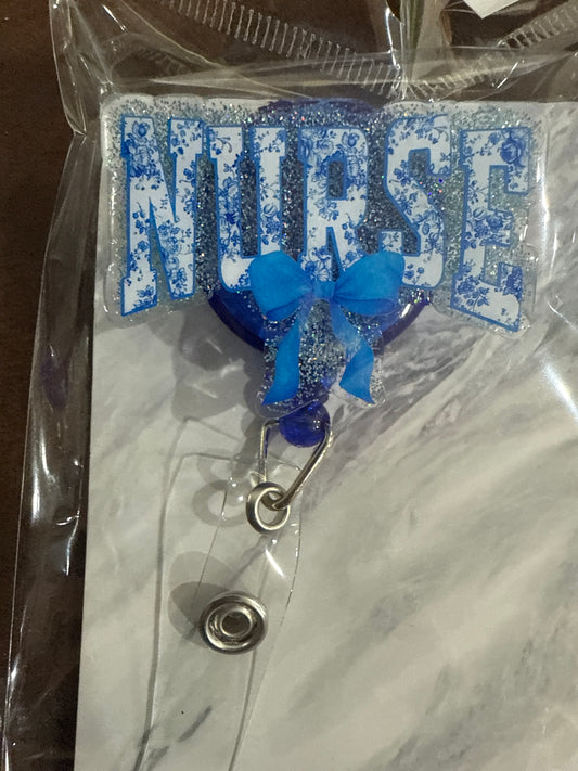 AUCTION 47 - Blue "NURSE" with bow Badge Reel - Iridescent